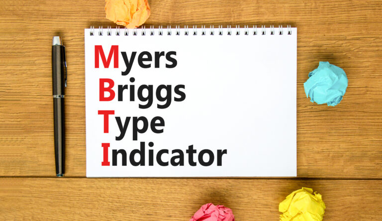 MBTI Myers Briggs type indicator symbol. Concept words MBTI Myers Briggs type indicator on white note on beautiful wooden background. Psychological MBTI Myers Briggs type indicator concept.