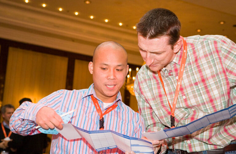 Two men talking at an event